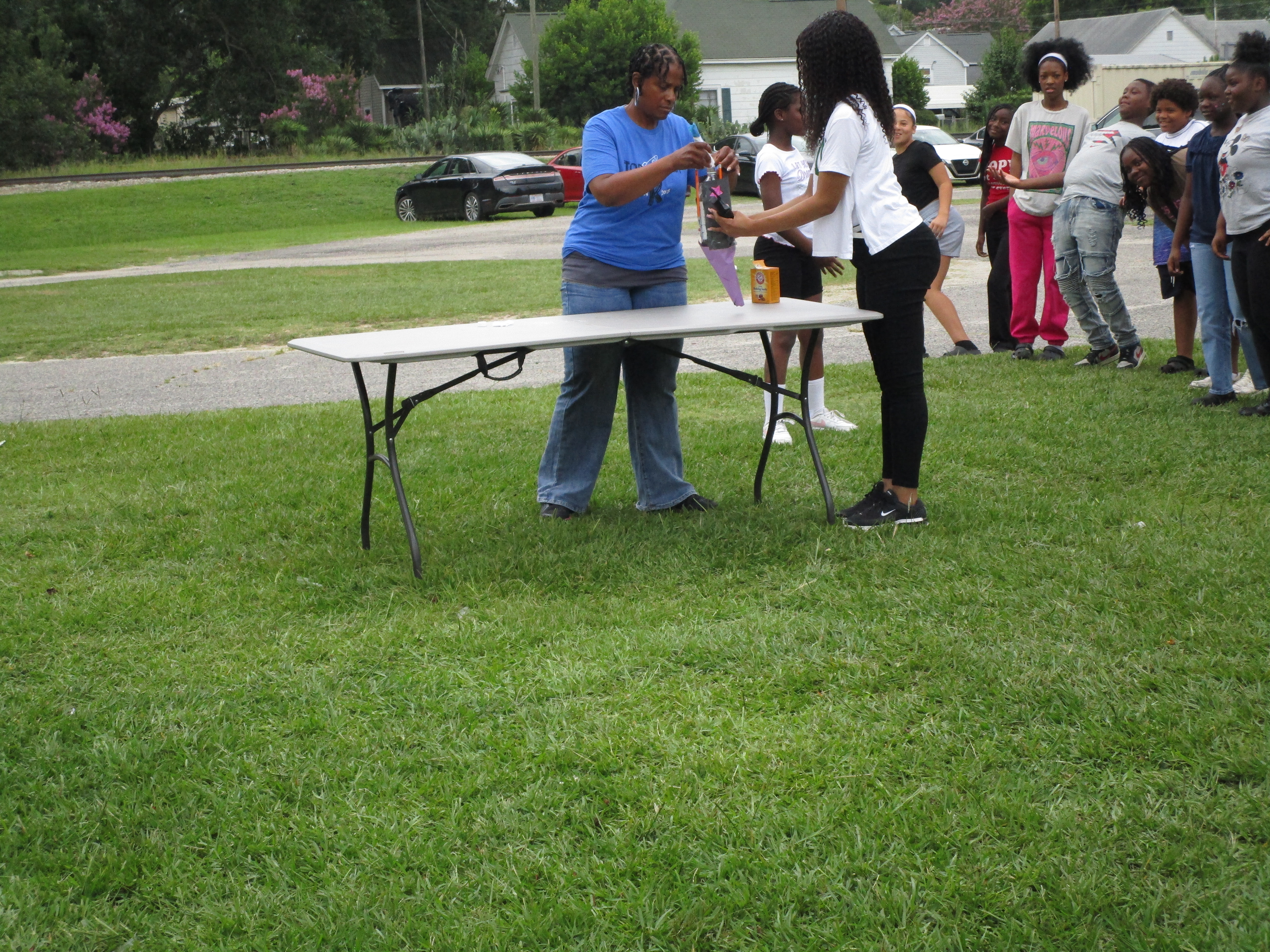 Fifth graders explored chemistry by creating baking soda and vinegar rockets, observing how a chemical reaction produces carbon dioxide gas to generate enough pressure to launch their rockets into the air.